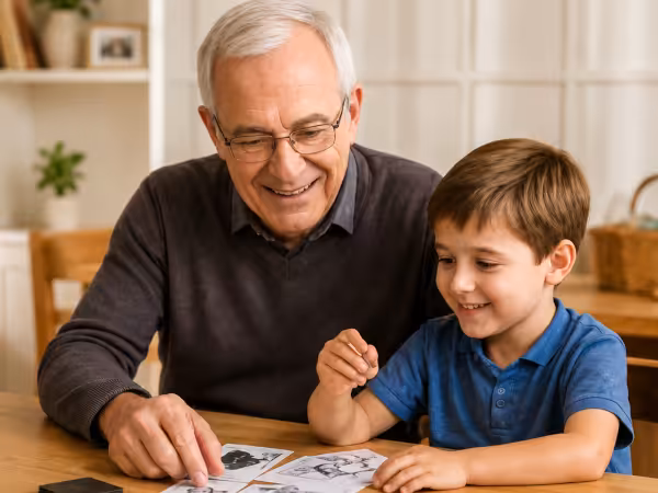 Grandfather and child enjoying a learning card game together at a table.
