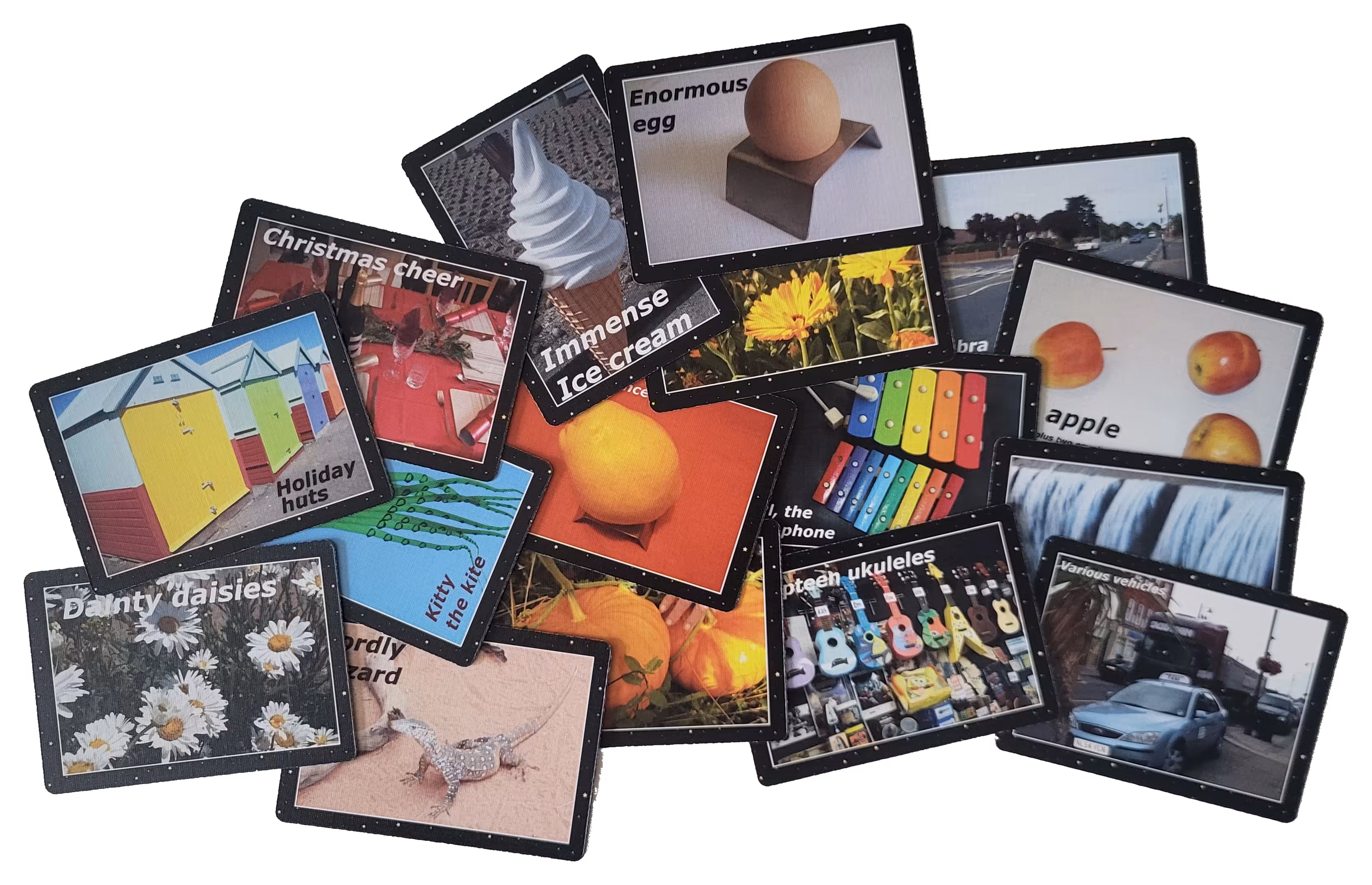 Overlapping black NoW vocabulary cards featuring colourful pictures and descriptive words.